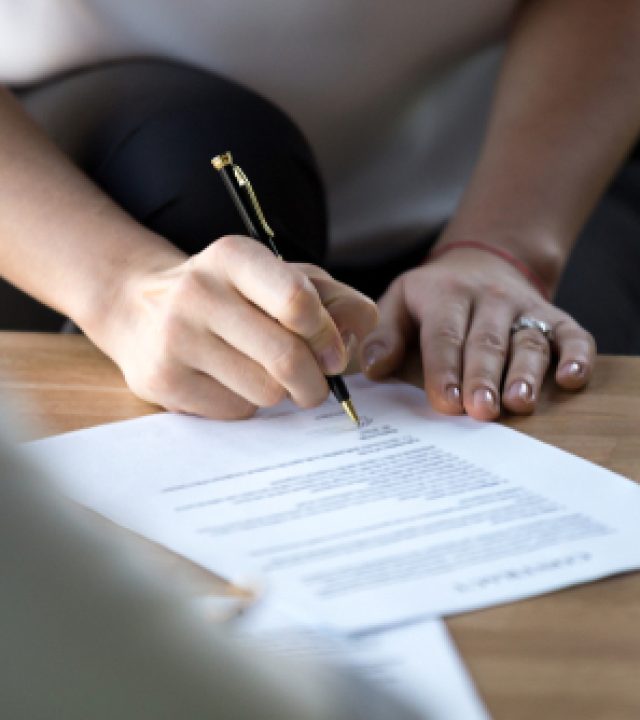 Close,Up,Of,Businesswoman,Hand,Holding,Ballpoint,After,Checking,Official